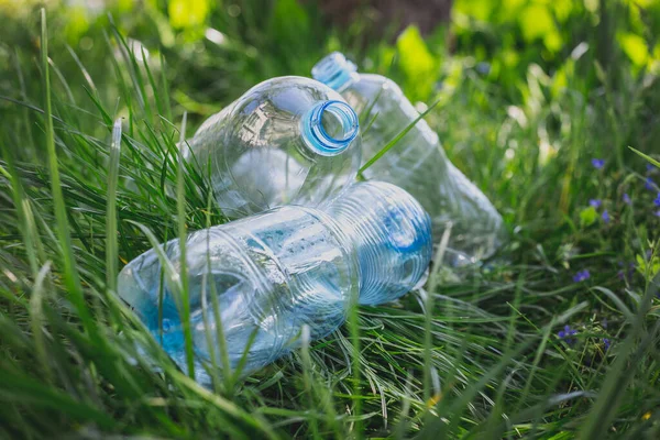plastic bottles in the grass, environmental pollution, environmental problems, the destruction of the eco system with plastic. garbage, waste