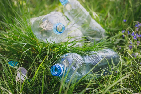 plastic bottles in the grass, environmental pollution, environmental problems, the destruction of the eco system with plastic. garbage, waste