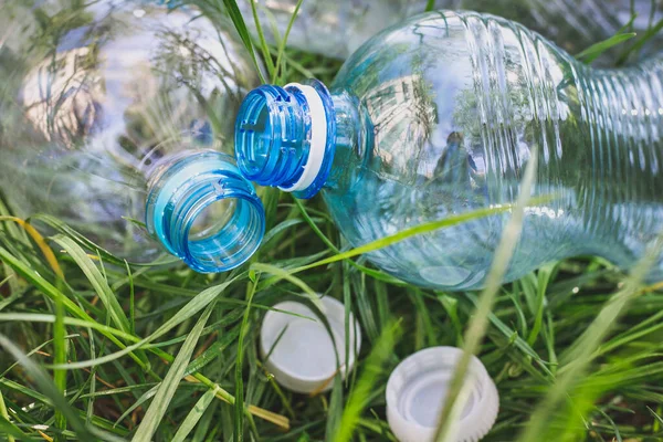 plastic bottles in the grass, environmental pollution, environmental problems, the destruction of the eco system with plastic. garbage, waste