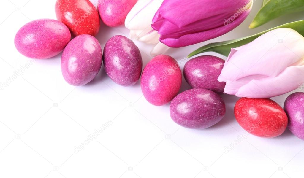Close-up of chocolate eggs and tulips
