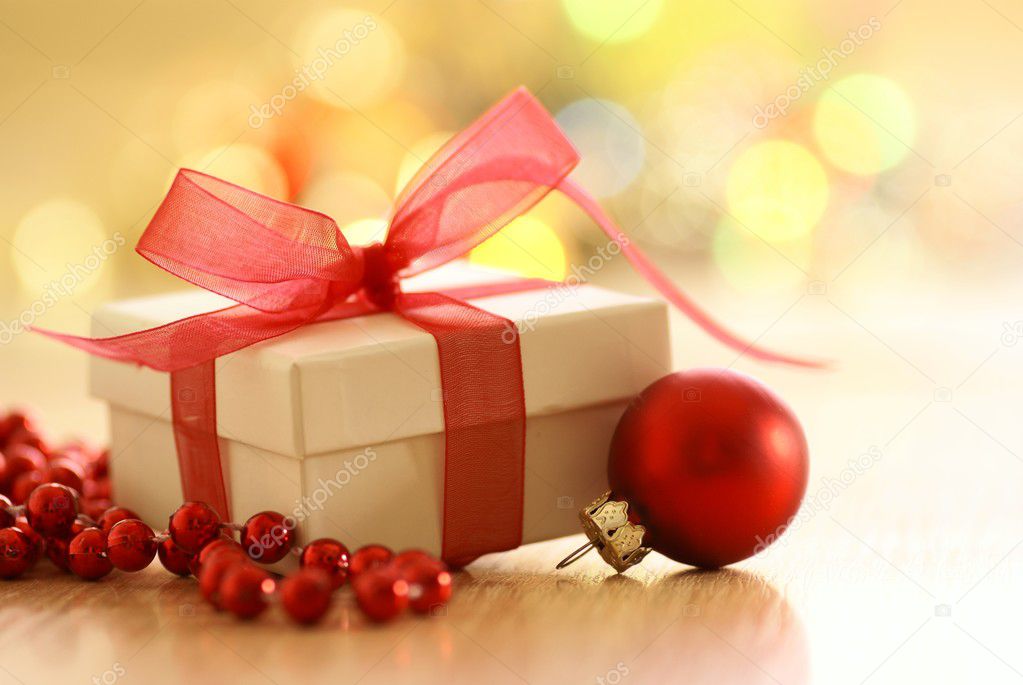 Gift with red ribbon and Christmas decorations