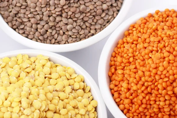 Three kinds of lentil in bowls — Stockfoto