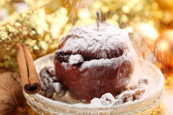Baked apple on plate and pouring sugar — Stock Photo, Image
