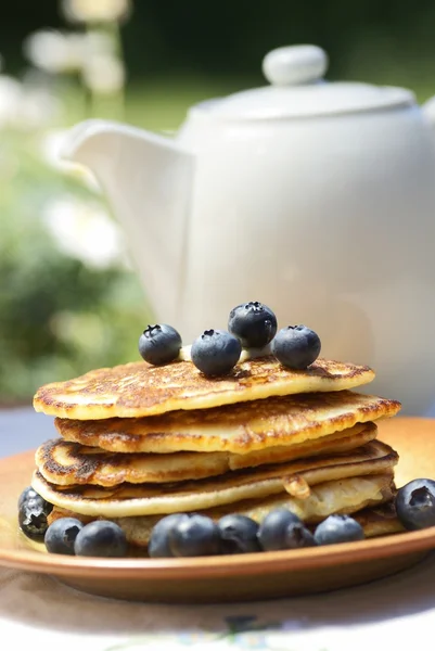 Stack of pancakes with blueberries and jug — Stock Photo, Image