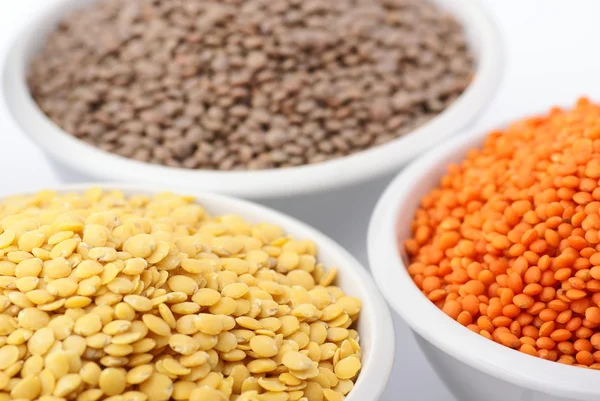 Three kinds of lentil in bowls — Stockfoto