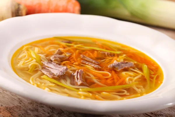 Plate with beef soup and vegetables — Stock Photo, Image