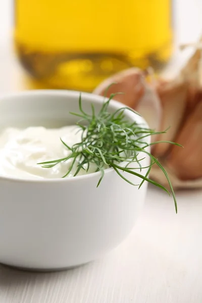 Close-up of bowl with yogurt and dill. — Stock Photo, Image