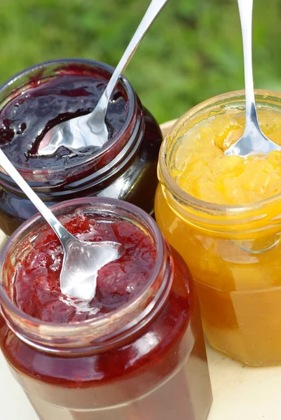 Glass with different kinds of jam. — Stock Photo, Image