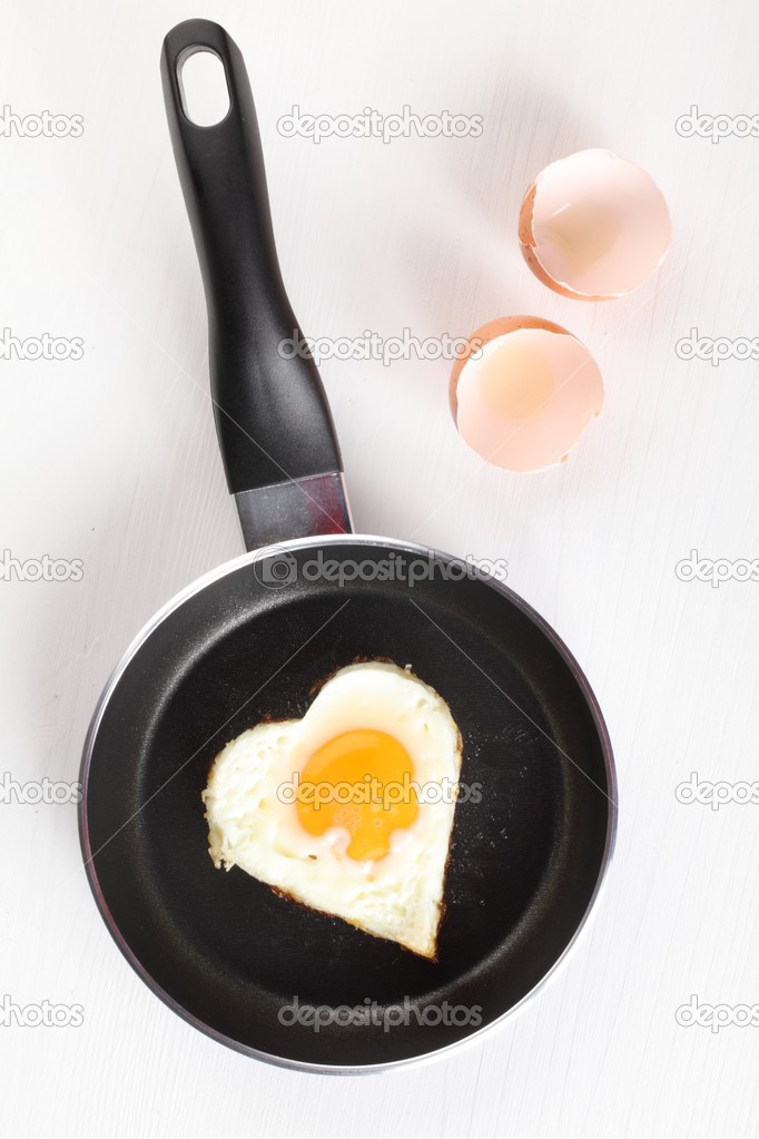 Fried egg (heart shape) on frying pan