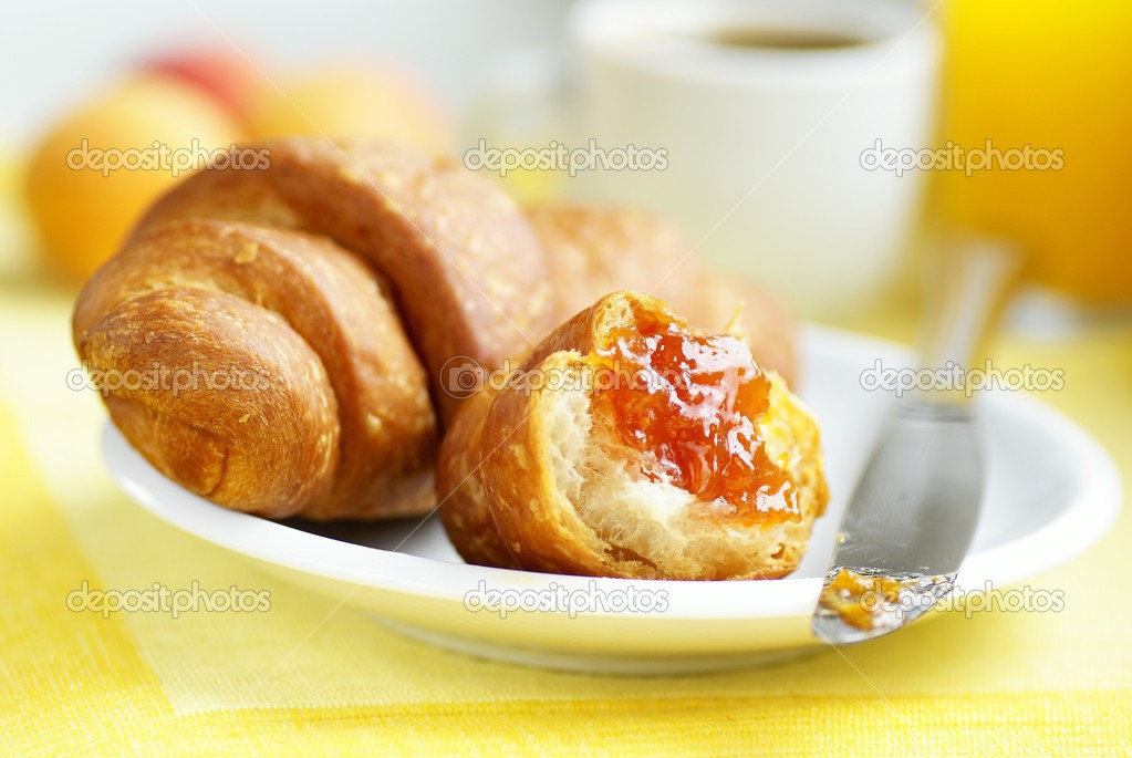 Croissant, apricot jam, apricots and coffee.