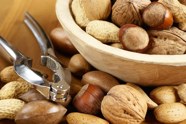 Wooden bowl with nuts — Stock Photo, Image