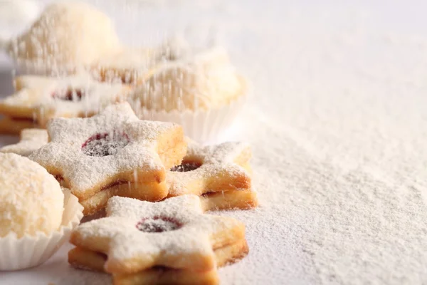Christmas cookies and pouring sugar — Stock Photo, Image
