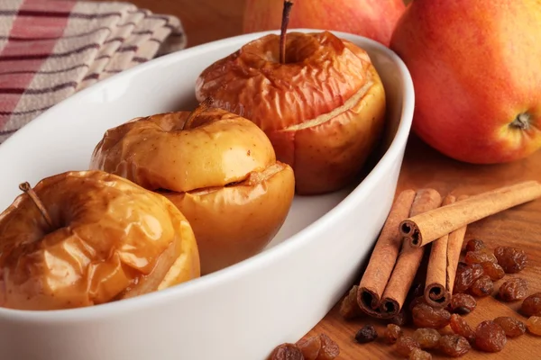 Baked apples in white bowl and ingredients. — Stock Photo, Image