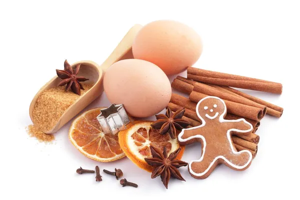 Gingerbread cookie and ingredients for Christmas baking on white background. — Stock Photo, Image