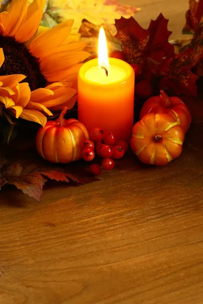 Arrangement of sunflower, candle and autumn decorations — Stock Photo, Image