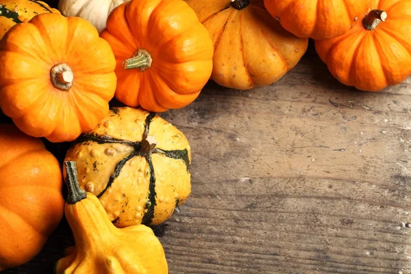 Pumpkins frame on wooden table — Stock Photo, Image