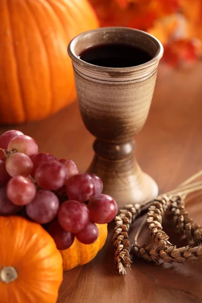 Chalice with wine, grapes, corn and pumpkins — Stock Photo, Image