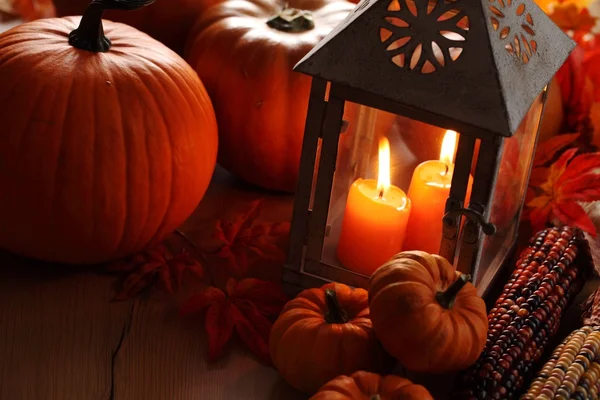 Lantern with burning candles and pumpkins — Stock Photo, Image