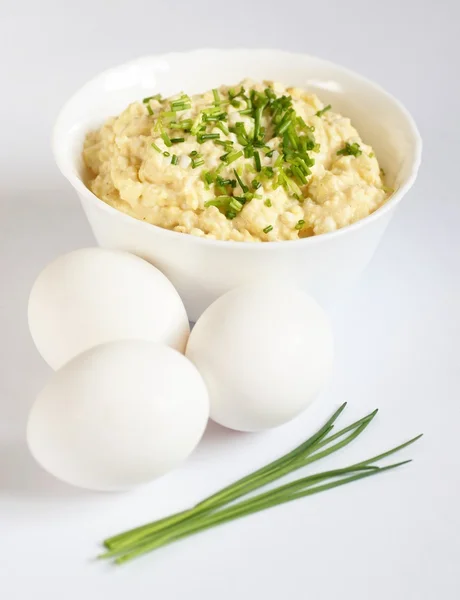 Cuenco blanco con huevo, huevos y cebollino —  Fotos de Stock