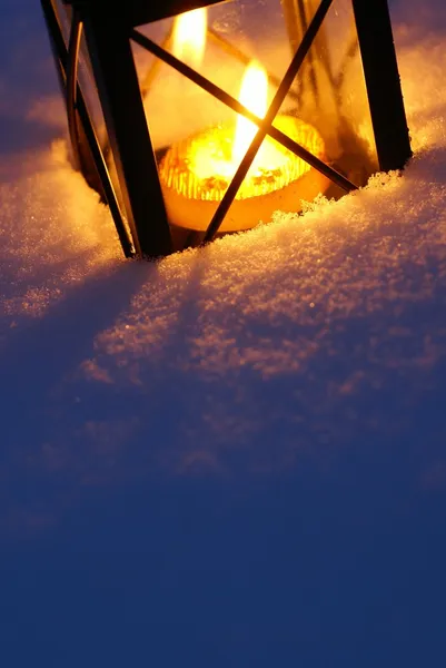 Lantern with burning candle on snow — Stock Photo, Image
