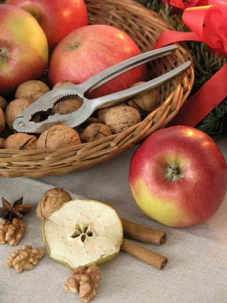 Basket with apples, walnuts and nutcracker. — Stock Photo, Image