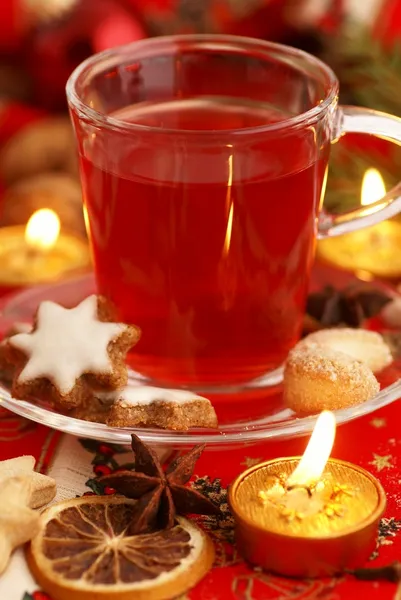 Glass with tea, Christmas cookies, spices and decorations — Stock Photo, Image