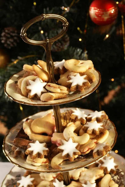 Christmas cookies on holiday plates. — Stock Photo, Image