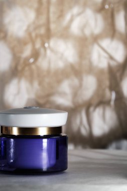 Close-up of a blue jar with cosmetics on an abstract background. Selective focus. Space for lettering and design