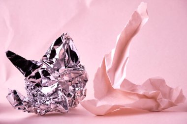 Abstract pink background with crumpled paper and foil elements. Selective focus. Backing for lettering, design and other creative purposes