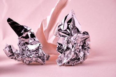Abstract pink background with crumpled paper and foil elements. Selective focus. Backing for lettering, design and other creative purposes
