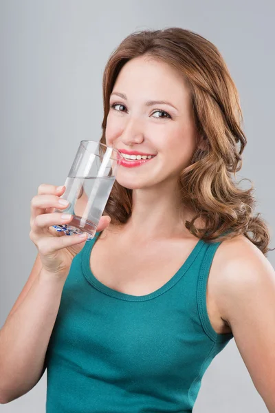 Lächelnde Frau trinkt Wasser — Stockfoto