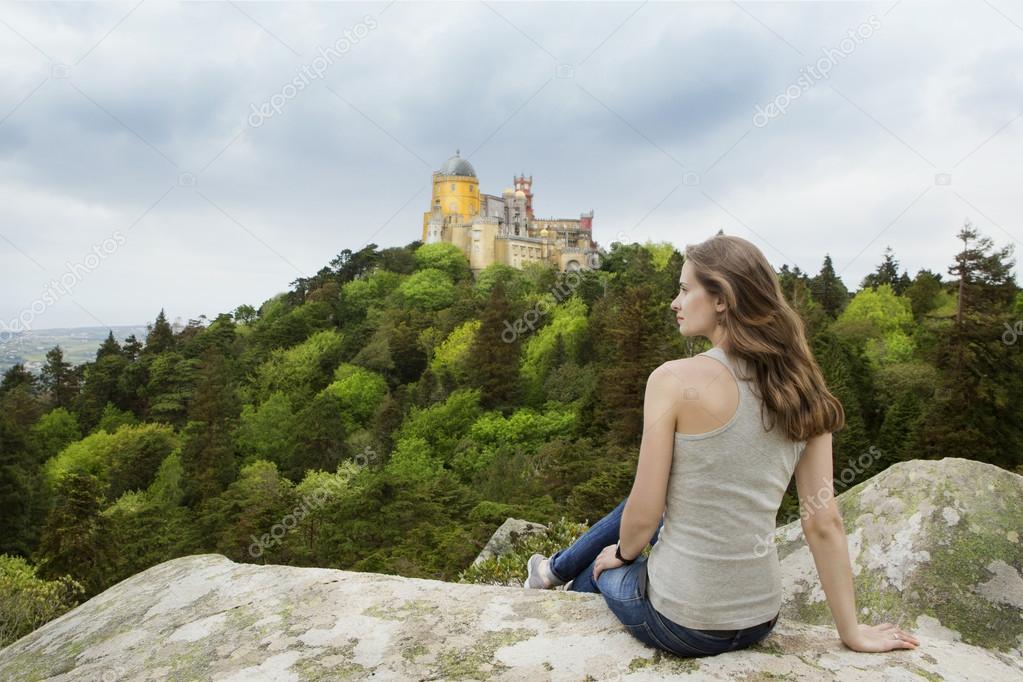 Girl looking at Pena Palace in Portugal.