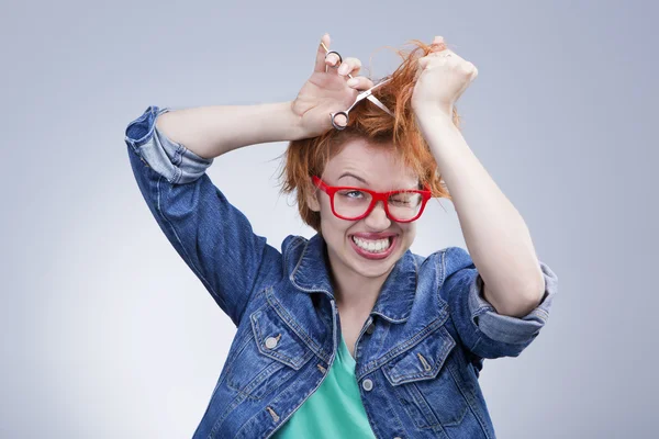 Young woman cuts her hair with scissors Hairdressing — Stock Photo, Image