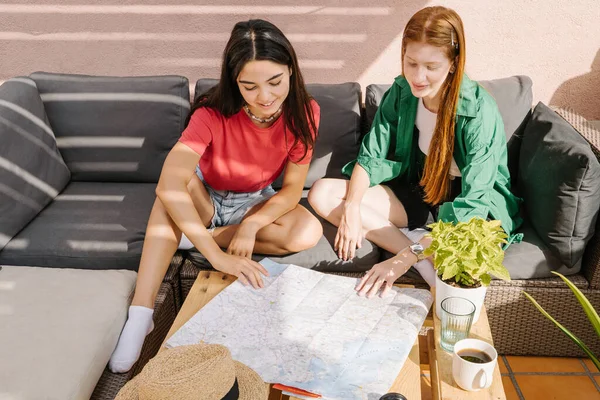 Young Friends Teen Girls Planning Summer Vacation Trip Map Sitting —  Fotos de Stock