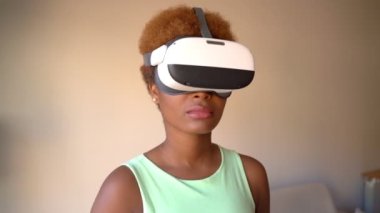 black skin young beautiful woman using VR glasses headset.   watching 360 degree video  with virtual reality. footage. calm focused emotions. bored dancing while waiting