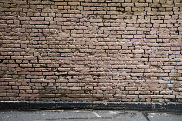 Old brick walls, coloured yellow and pink