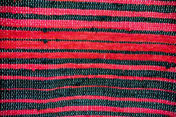 Strip woven red and black rug surface close up — Stock Photo, Image