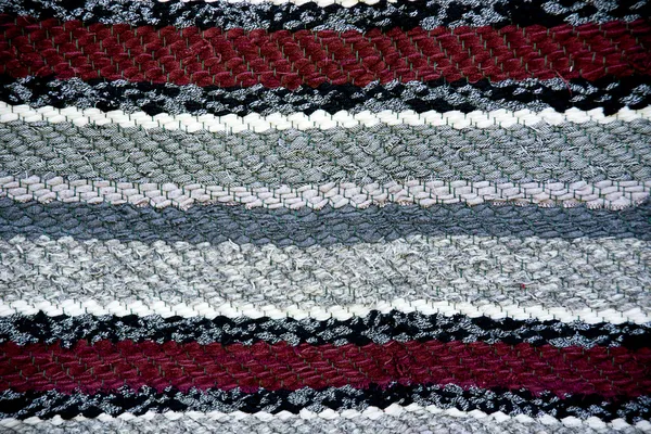 Strip woven red and gray rug surface close up. — Stock Photo, Image