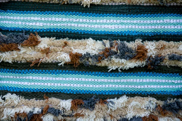 Strip blue woven  rug surface with fringe close up. Baltic handm — Stock Photo, Image