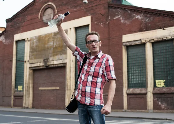 Man celebrate German football victory with a bottle of vodka