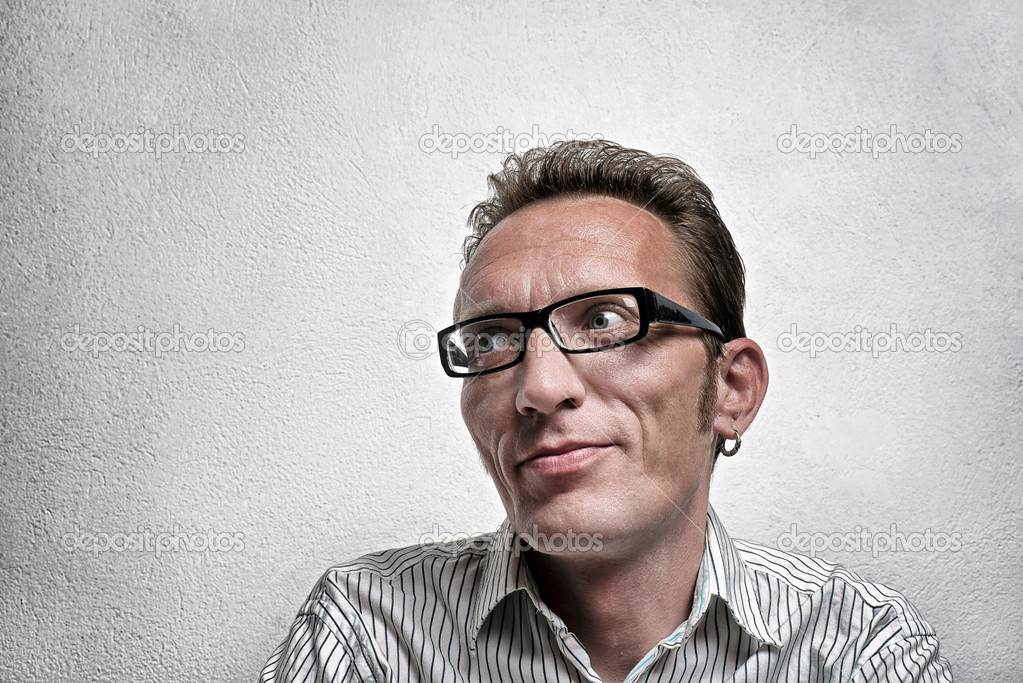 Close up portrait quit satisfied man with eyeglasses looking left and up with flirty flattery smile.