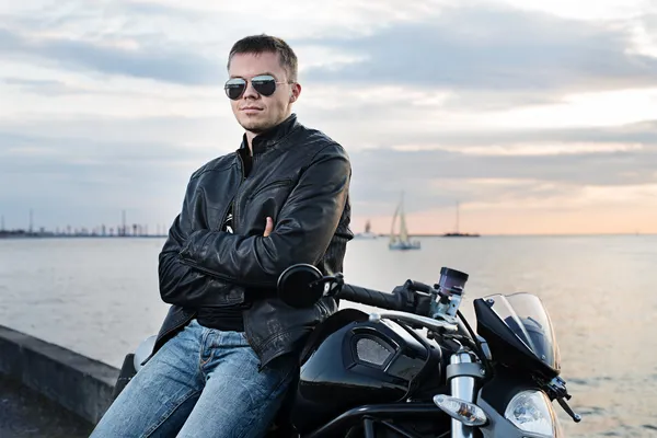 Handsome young man in leather jacket on motorcycle — Stock Photo, Image