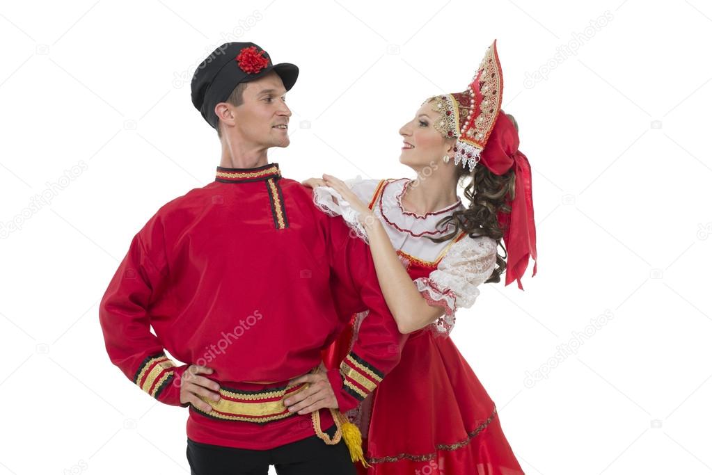 Conversation young couple in russian traditional costumes, girl in red sarafan and kokoshnik