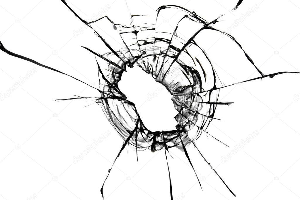 Cracks from a bullet in the glass. Broken glass shot. Abstract texture on white background