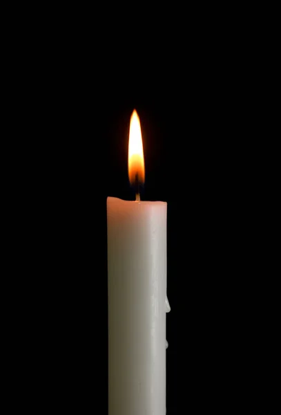 One candle with light isolated on a black background — Fotografia de Stock