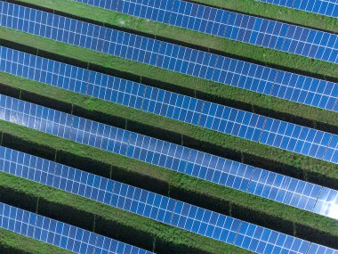 Güneşli bir günde güneş enerjisi santralinin insansız hava aracı görüntüsü. İnsansız hava aracı ile güneş çiftliği sistemi. Ekolojik yenilenebilir enerji kaynağı.