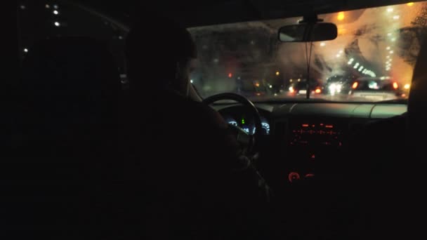 Das Auto in der Nacht im Regen beginnt sich bei grünem Licht zu bewegen — Stockvideo