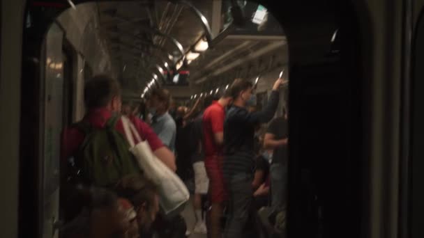 KIEV, UKRAINE - JULY 15, 2021: shooting underground metro carriage filled with people medical masks. — 图库视频影像