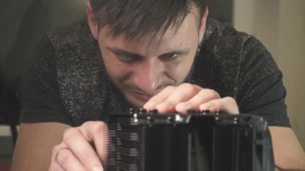 A man collects components for a system case, a computer. Close-up — Stock Video