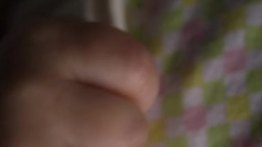 close-up, macro of a small fist, fingers, baby handles.